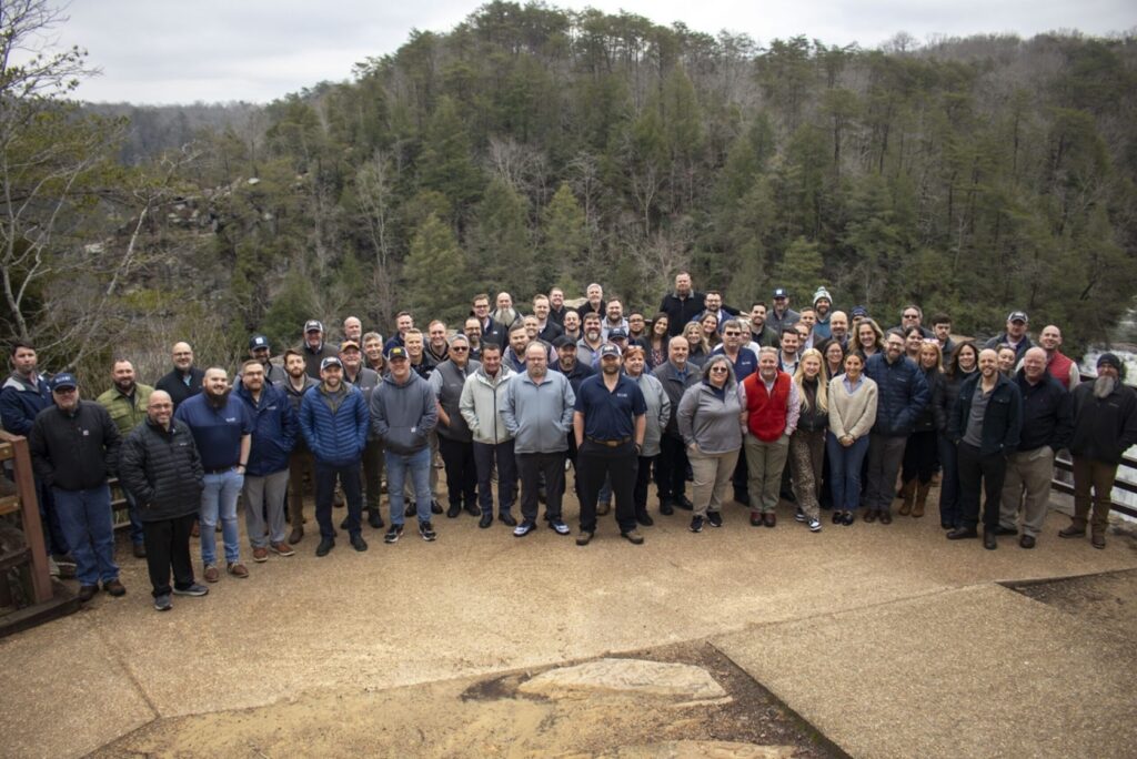 Bailey Equipment and Intralogistics staff with forest in the background