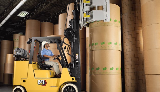 Bailey Forklift Operator Handling Large Paper Rolls in Warehouse