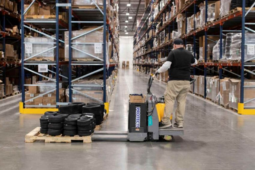 Bailey Warehouse Worker Operating a Jungheinrich ERE BB 220 Electric Pallet Mover. 
