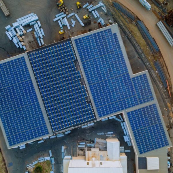 Aerial view of a large rooftop solar panel installation at an industrial site in Tennessee and Kentucky